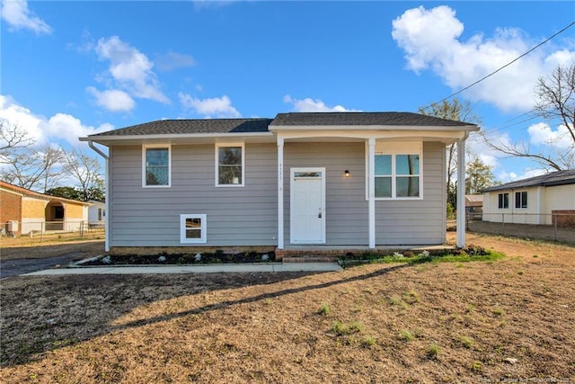 view of front of property with fence and a front lawn