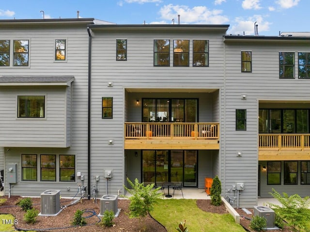 rear view of property with cooling unit and a patio area