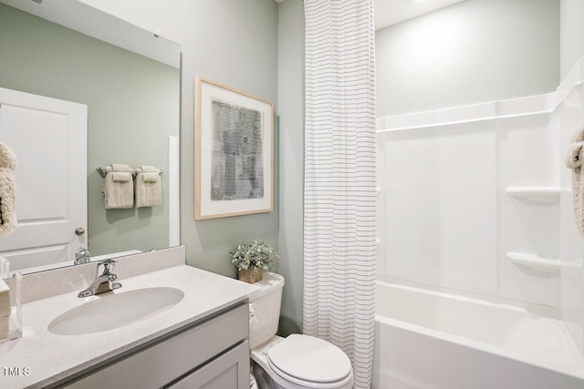 full bathroom with vanity, shower / tub combo, and toilet