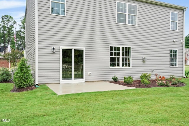 back of property featuring a yard and a patio