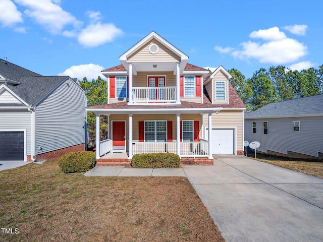 traditional home featuring an attached garage, covered porch, a balcony, a front lawn, and driveway