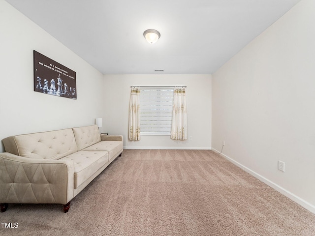 carpeted living area with baseboards and visible vents