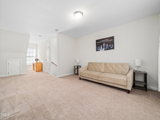 carpeted living area featuring baseboards and visible vents