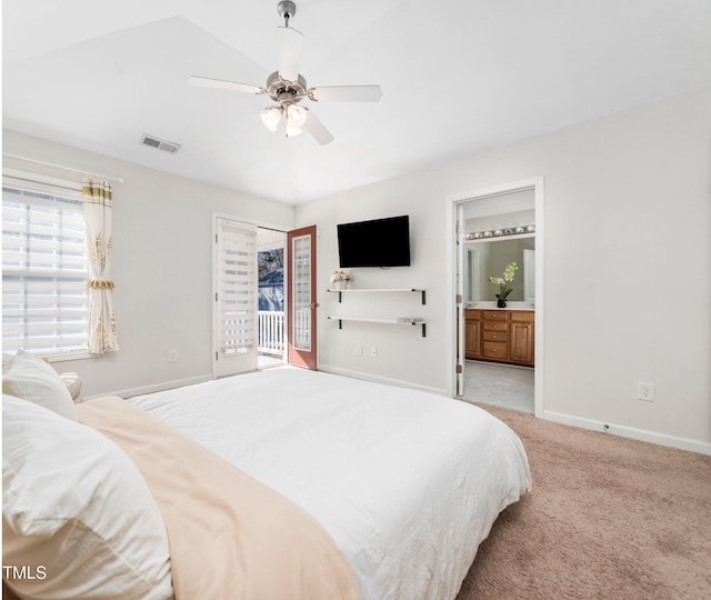 bedroom with baseboards, ensuite bath, visible vents, access to exterior, and light colored carpet