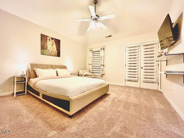 carpeted bedroom with visible vents, baseboards, ceiling fan, and lofted ceiling
