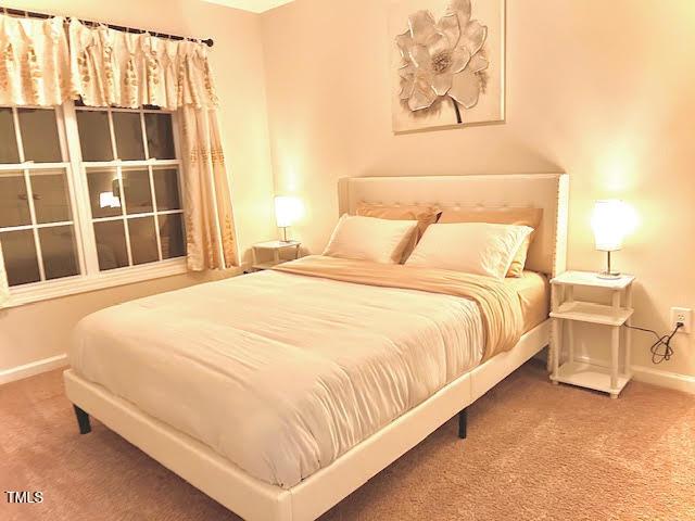 carpeted bedroom featuring baseboards