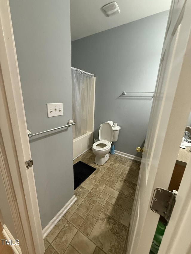 bathroom with toilet and shower / bath combo