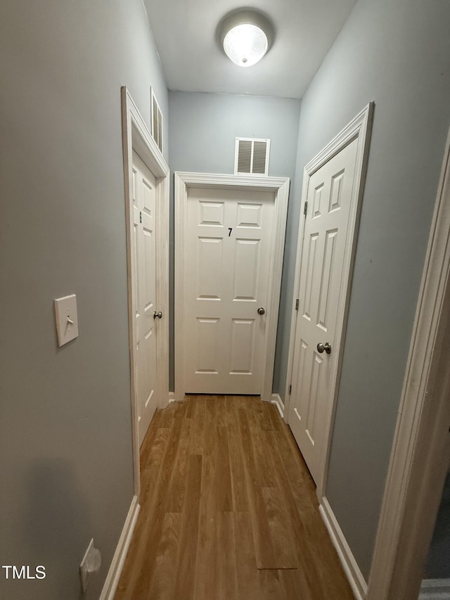 doorway with hardwood / wood-style flooring