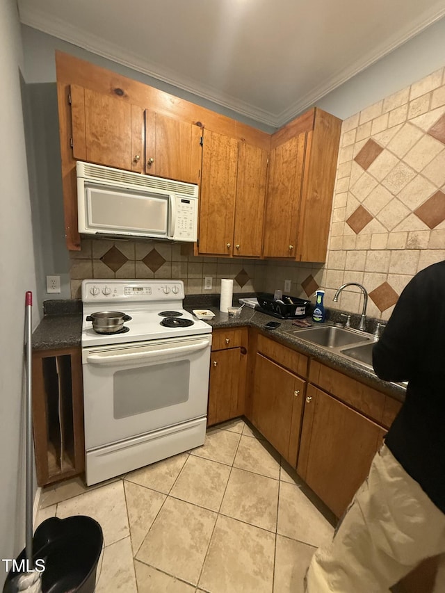 kitchen featuring tasteful backsplash, sink, white appliances, and ornamental molding