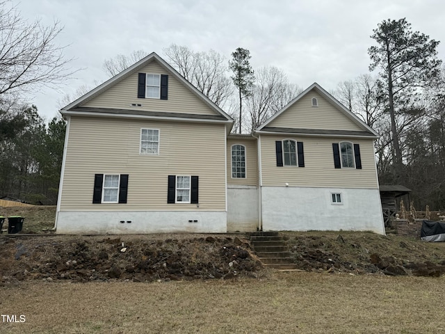 rear view of house with a yard