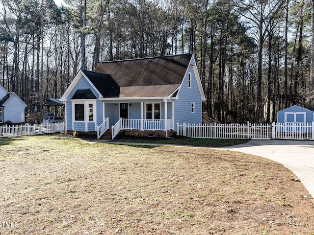 view of front facade with a porch, a shed, and a front yard