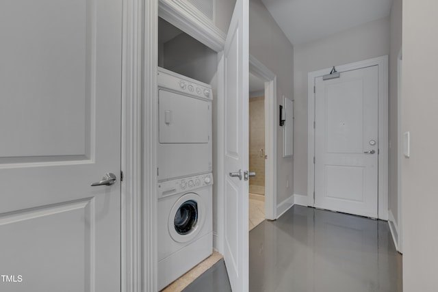 washroom featuring stacked washing maching and dryer