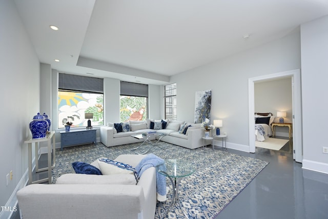 living area with baseboards, recessed lighting, and finished concrete flooring