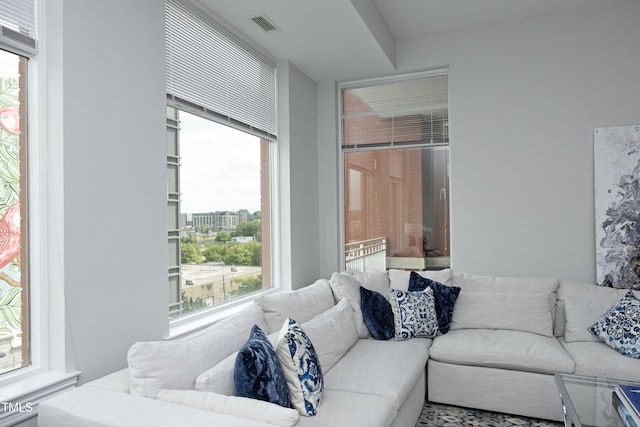 living area with a healthy amount of sunlight and visible vents