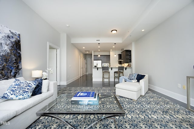 living area featuring recessed lighting and baseboards