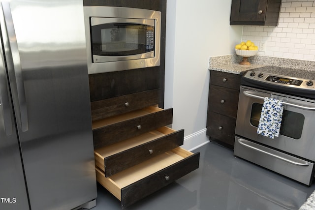 kitchen with baseboards, decorative backsplash, dark brown cabinetry, and stainless steel appliances