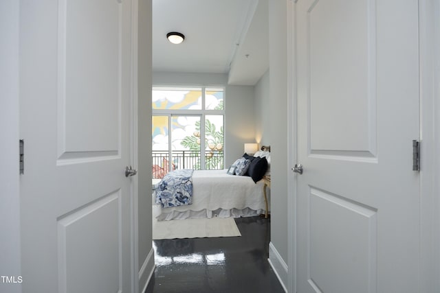 bedroom with baseboards and access to outside