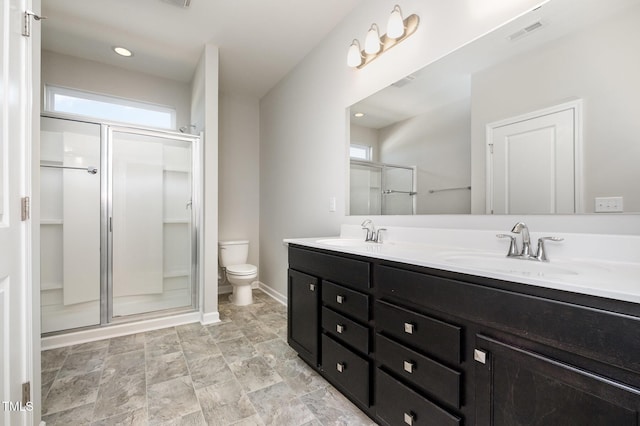 bathroom featuring vanity, toilet, and walk in shower