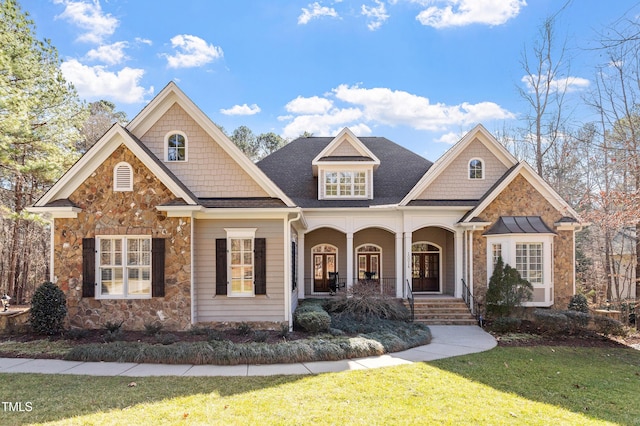 craftsman-style home with a front yard and covered porch