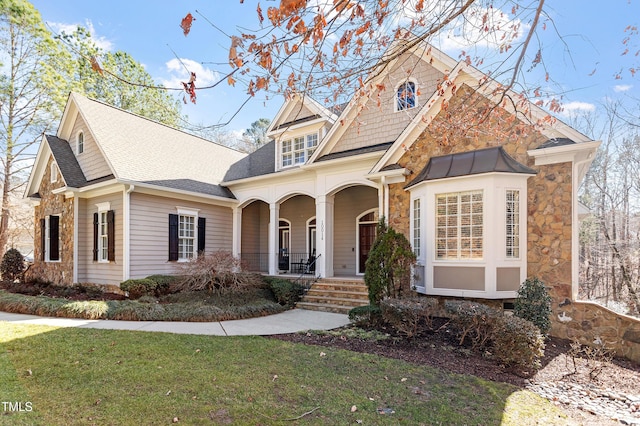 view of front of home featuring a front lawn and covered porch