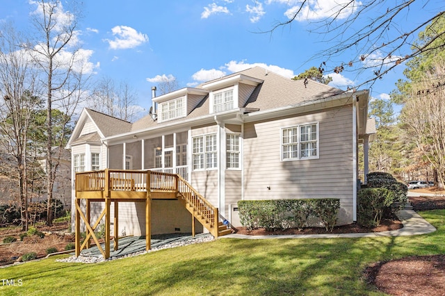 back of property featuring a yard, a deck, and a sunroom