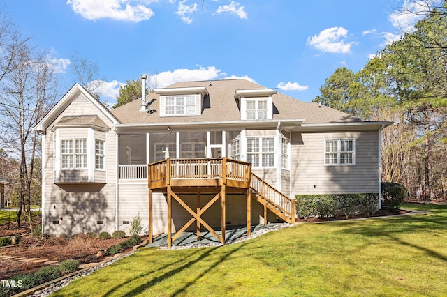 back of house featuring a lawn, a sunroom, and a deck