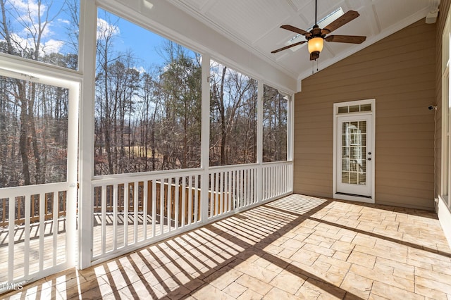 unfurnished sunroom with ceiling fan and lofted ceiling