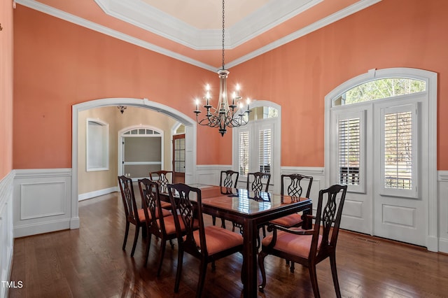 dining area with a notable chandelier, crown molding, and dark hardwood / wood-style floors