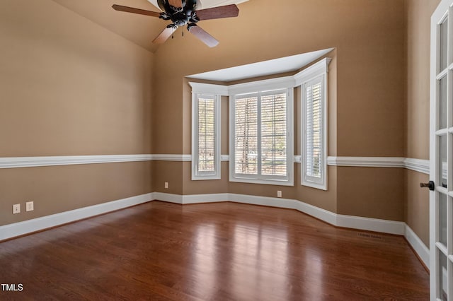 empty room featuring hardwood / wood-style flooring, ceiling fan, and vaulted ceiling