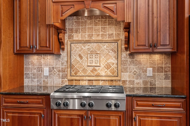 kitchen with tasteful backsplash, stainless steel gas cooktop, and dark stone countertops