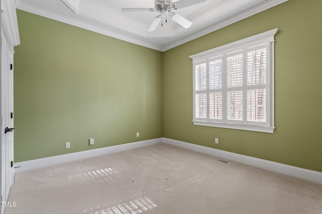 empty room featuring crown molding, light colored carpet, and ceiling fan