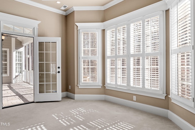 entryway featuring ornamental molding and light carpet