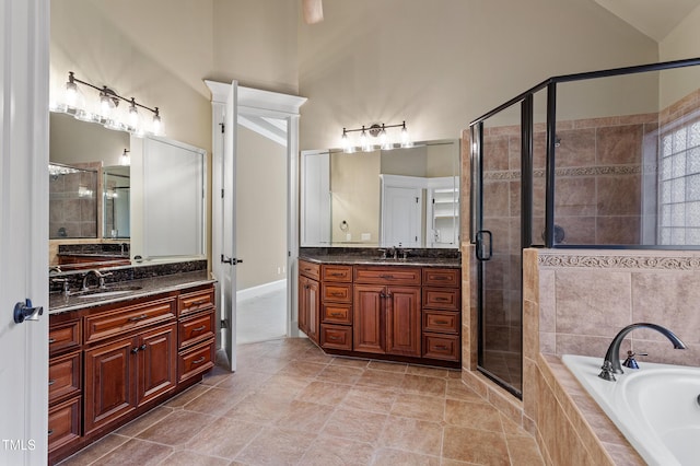 bathroom featuring vanity, plus walk in shower, tile patterned flooring, and vaulted ceiling