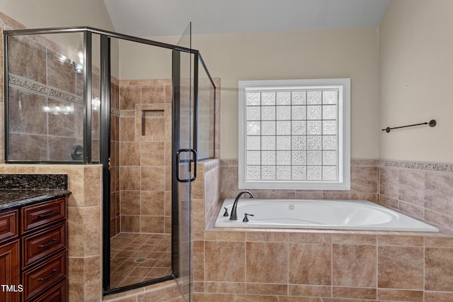 bathroom featuring vanity and shower with separate bathtub