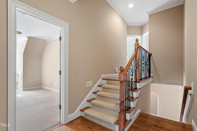 stairs featuring ornamental molding and hardwood / wood-style floors