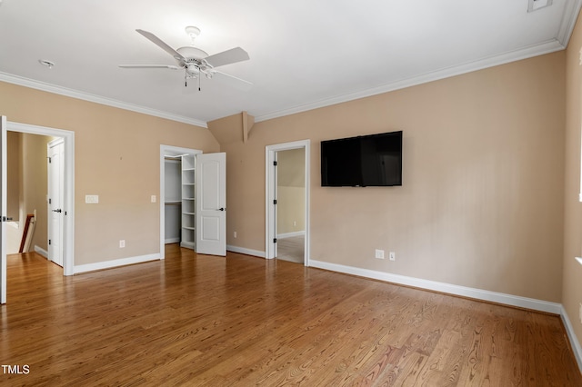 unfurnished room with wood-type flooring, ornamental molding, and ceiling fan