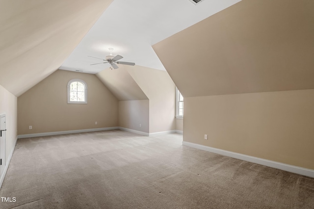 bonus room featuring lofted ceiling, light colored carpet, and ceiling fan