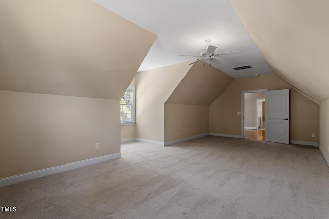 additional living space featuring ceiling fan, light colored carpet, and lofted ceiling