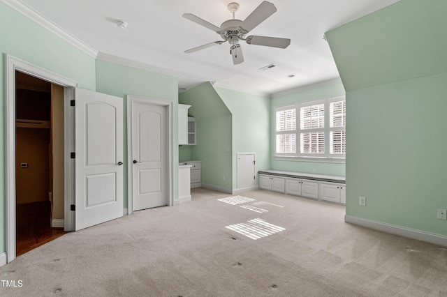 unfurnished bedroom featuring crown molding, light carpet, and ceiling fan