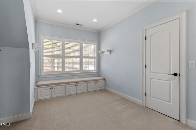 unfurnished bedroom featuring light carpet and crown molding