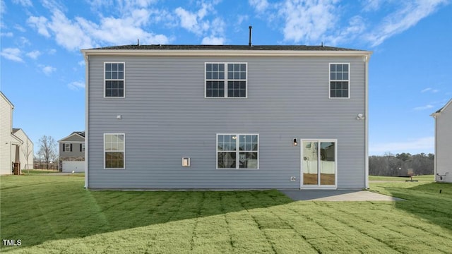 back of property featuring a yard and a patio area