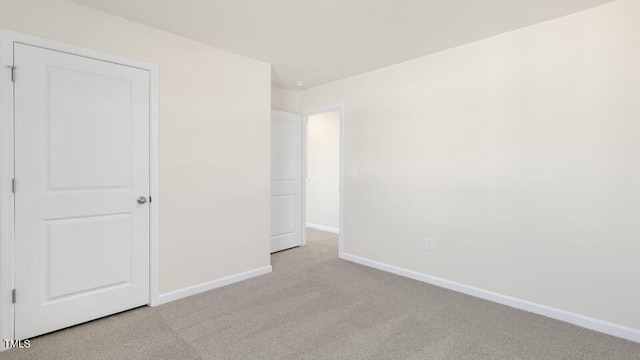 unfurnished bedroom with light colored carpet