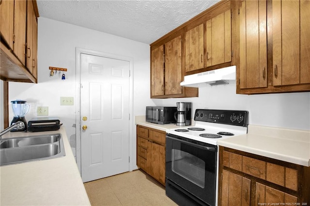 kitchen with range with electric cooktop, sink, and a textured ceiling