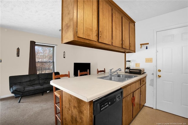 kitchen with sink, dishwasher, a kitchen breakfast bar, a textured ceiling, and kitchen peninsula