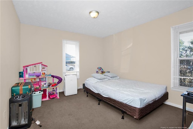 bedroom featuring dark carpet