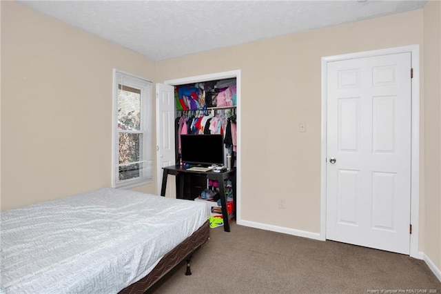 bedroom with a closet, a textured ceiling, and carpet flooring