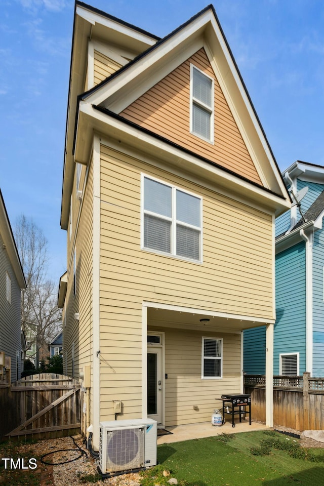 back of property featuring a yard, ac unit, and a patio area