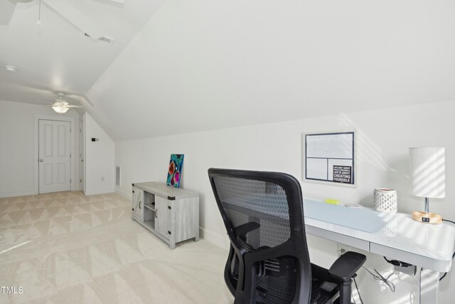 carpeted home office with lofted ceiling and ceiling fan