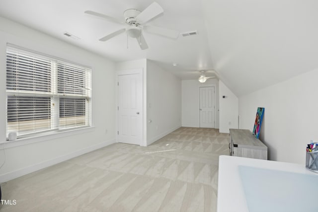 bonus room with ceiling fan, light colored carpet, and lofted ceiling