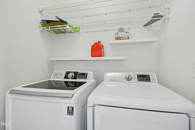 clothes washing area with independent washer and dryer